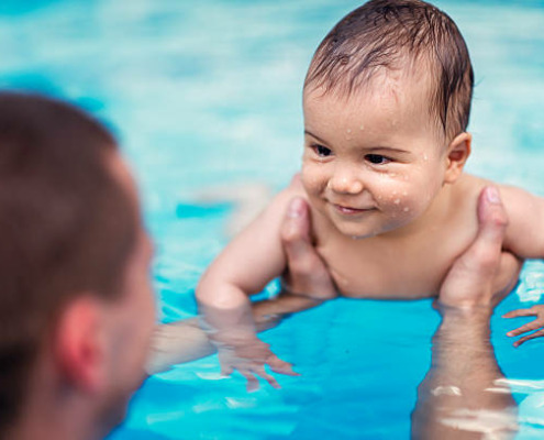 Smilling baby boy in swimming pool