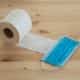 white toilet paper roll on brown wooden table