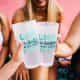 women holding two printed pint glasses