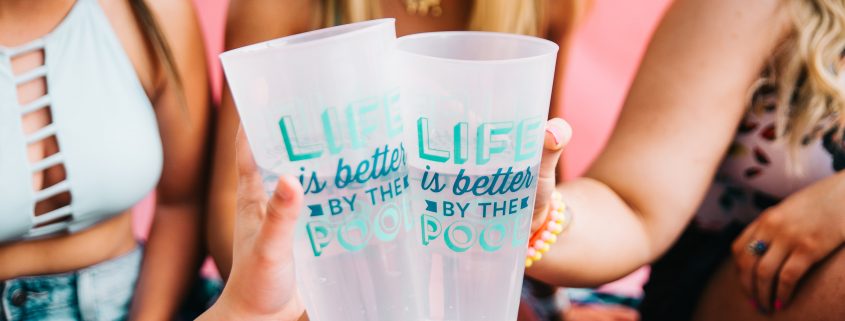 women holding two printed pint glasses