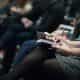selective focus photography of people sitting on chairs while writing on notebooks